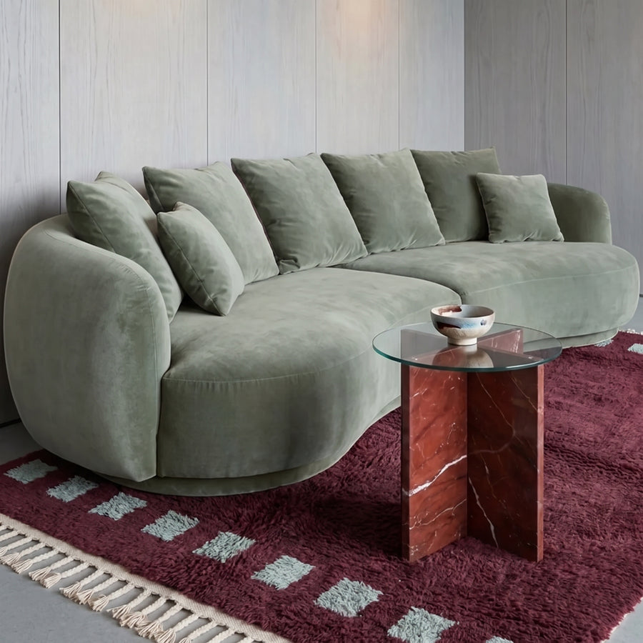 Burgundy and mint Beni Ourain rug in living room under curved sofa