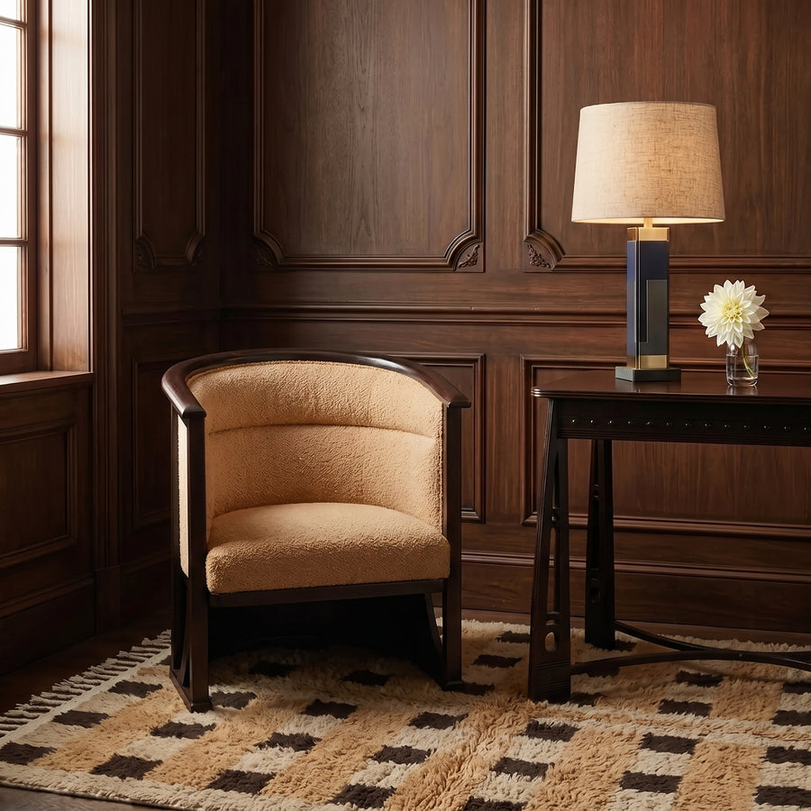 Camel and cocoa Beni Ourain checkerboard rug in a wood-panelled office setting with leather chair