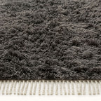 Corner detail of charcoal Beni Ourain showing dense pile and twisted ivory fringe