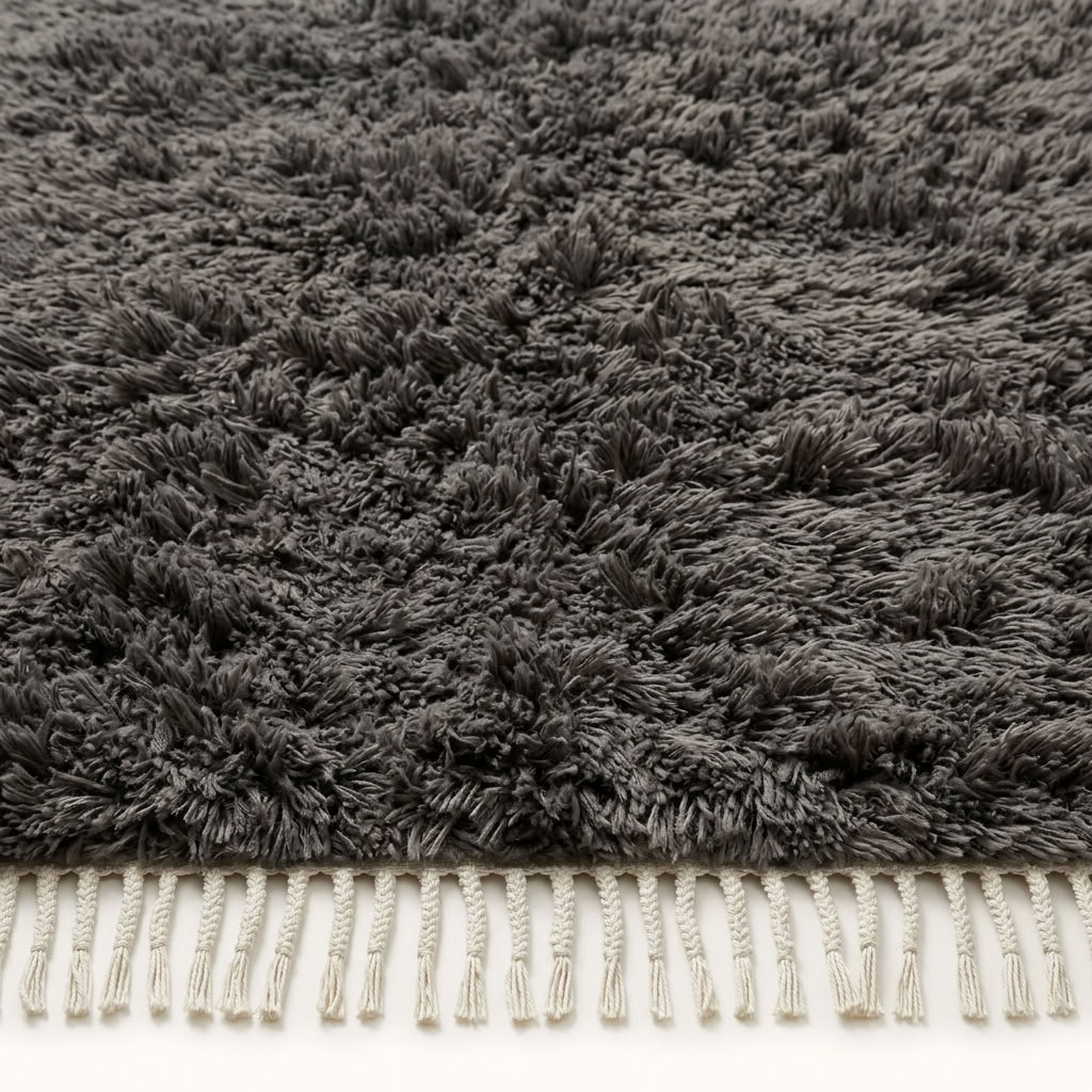 Corner detail of charcoal Beni Ourain showing dense pile and twisted ivory fringe