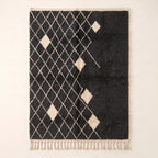 Charcoal and ivory Beni Ourain rug with diamond lattice pattern and scattered ivory diamond motifs, flat view on plain background