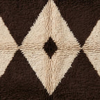 Angled view of Massa's central diamond with soft hand-knotted pile in brown and ivory, highlighting the dimensional texture