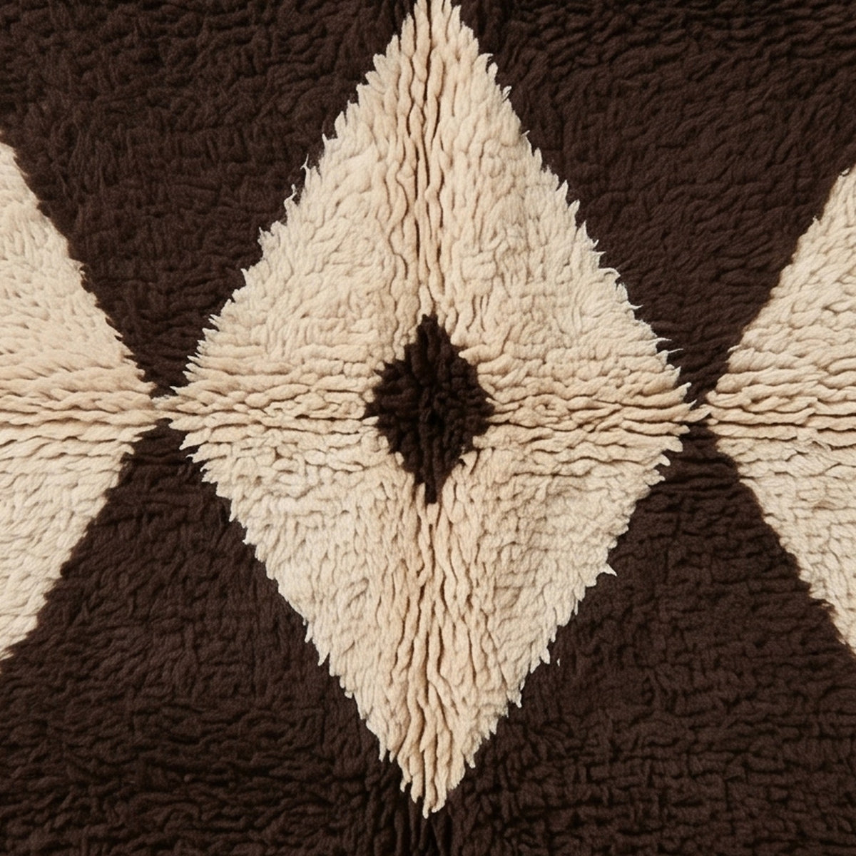 Angled view of Massa's central diamond with soft hand-knotted pile in brown and ivory, highlighting the dimensional texture