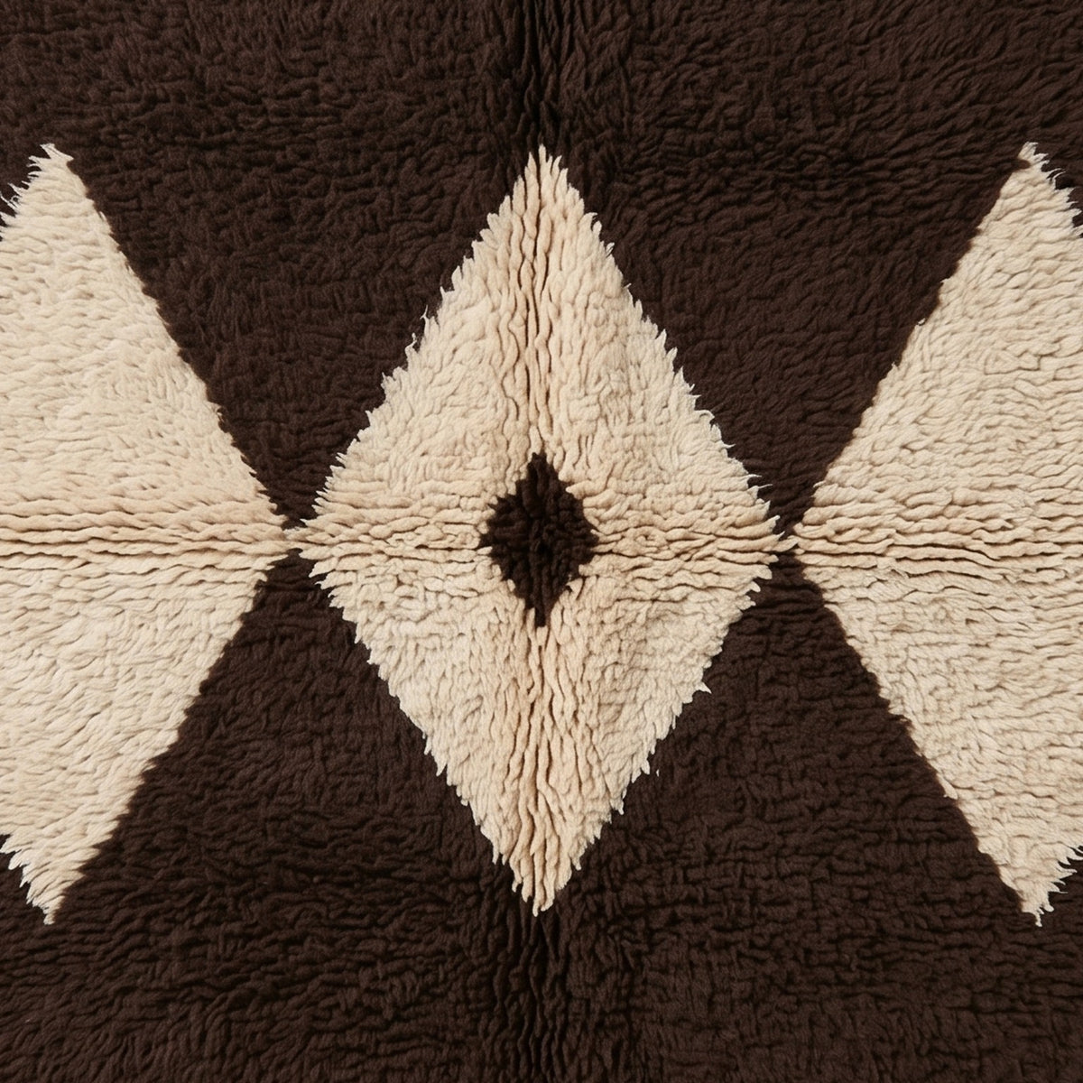 Overhead detail of Massa's diamond lattice pattern showing the contrast between chocolate brown and cream ivory wool knots