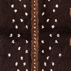 Detail of central cream column with scattered dots and hand-knotted texture showing colour variation