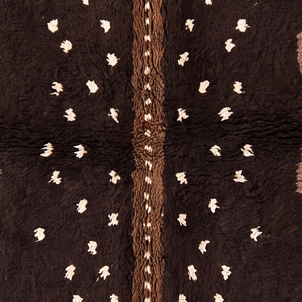 Detail of central cream column with scattered dots and hand-knotted texture showing colour variation