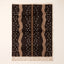 Chocolate and taupe Beni Ourain rug with scattered cream dots and wavy vertical columns on plain background