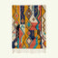 Full view of the Izuran Boujaad rug in coral, mustard, teal, navy and cream with vertical diamonds and linear motifs