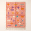 Coral Azilal rug with hand-drawn script and symbol scatter in purple, gold, turquoise, cream and white, photographed flat on plain background