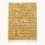 Cream Beni Ourain Yakout rug with textured horizontal stripes, flat lay on plain background