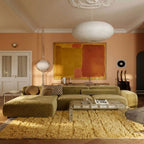 Cream Yakout rug in living room with olive sofa and modern decor