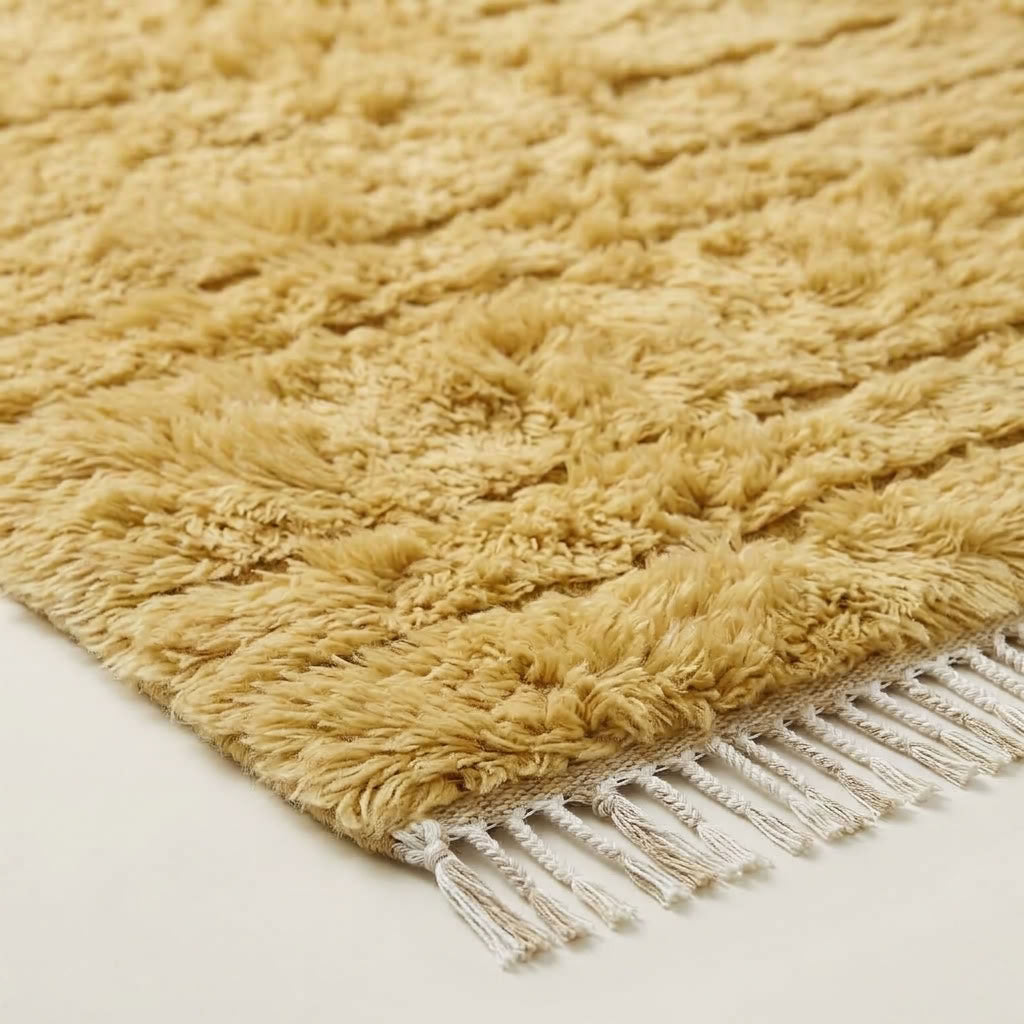 Close angled view of cream Yakout rug pile with visible horizontal texture bands
