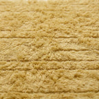 Angled detail of cream Beni Ourain Yakout showing dimensional stripe texture
