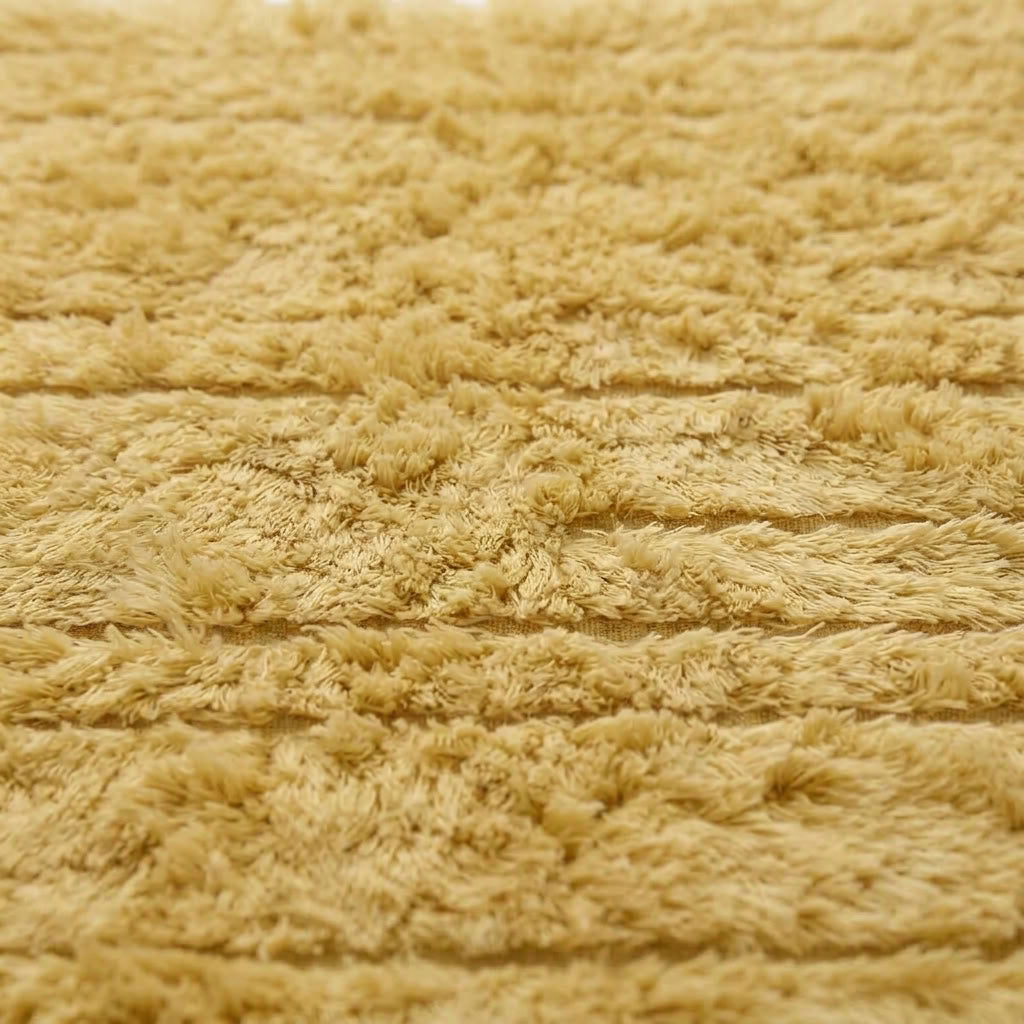 Angled detail of cream Beni Ourain Yakout showing dimensional stripe texture