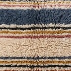 Close-up of the wide narrow pattern on the Aghbalu Moroccan wool pillow
