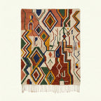 Full view of the Asifran Boujaad rug in cream, terracotta, forest green, mustard and navy with layered diamond lattice motifs