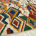 Close-up of the Asifran Boujaad rug showing plush cream and terracotta hand-knotted wool texture