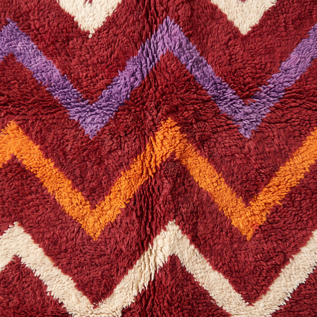 Close-up of chevron motif showing periwinkle, orange and ivory stripe intersection