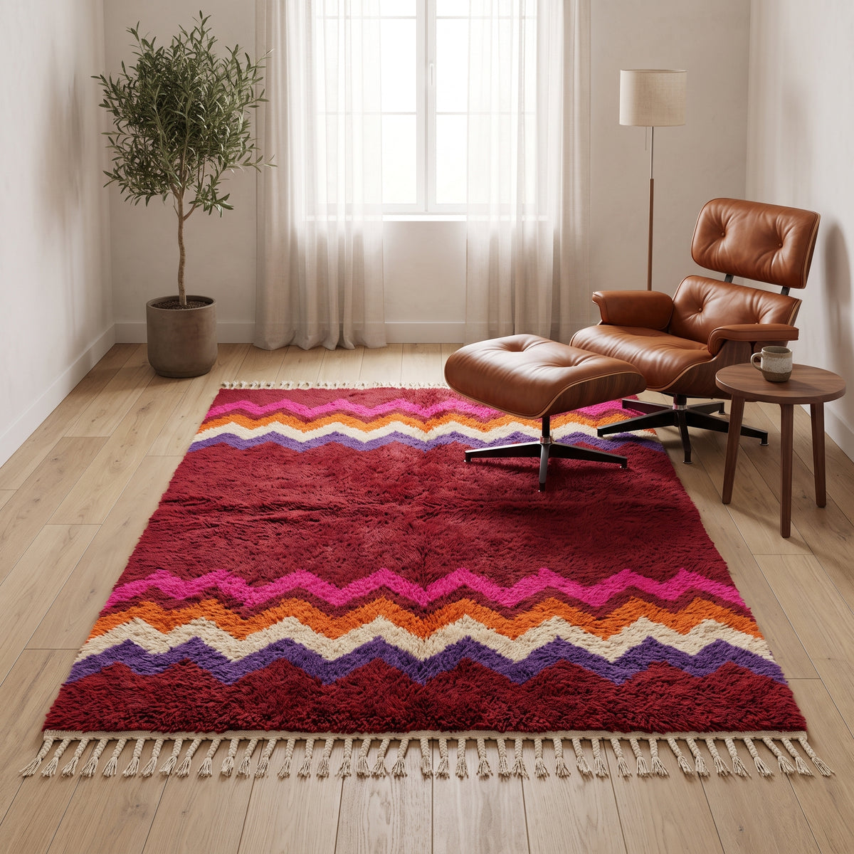 Crimson Boujaad chevron rug in modern living room with cognac leather chair and olive plant