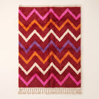 Flat view of crimson Boujaad rug with horizontal chevron stripes in magenta, orange, ivory and periwinkle