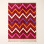 Flat view of crimson Boujaad rug with horizontal chevron stripes in magenta, orange, ivory and periwinkle