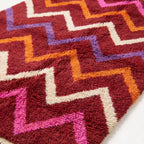 Close-up of plush wool pile showing chevron stripe texture and colour detail