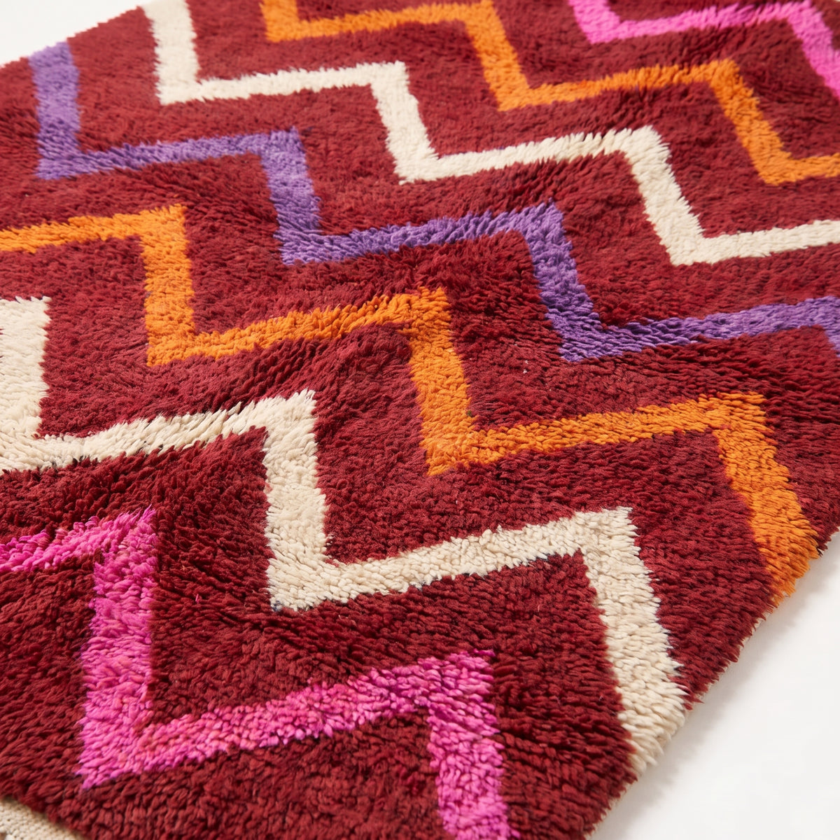 Close-up of plush wool pile showing chevron stripe texture and colour detail