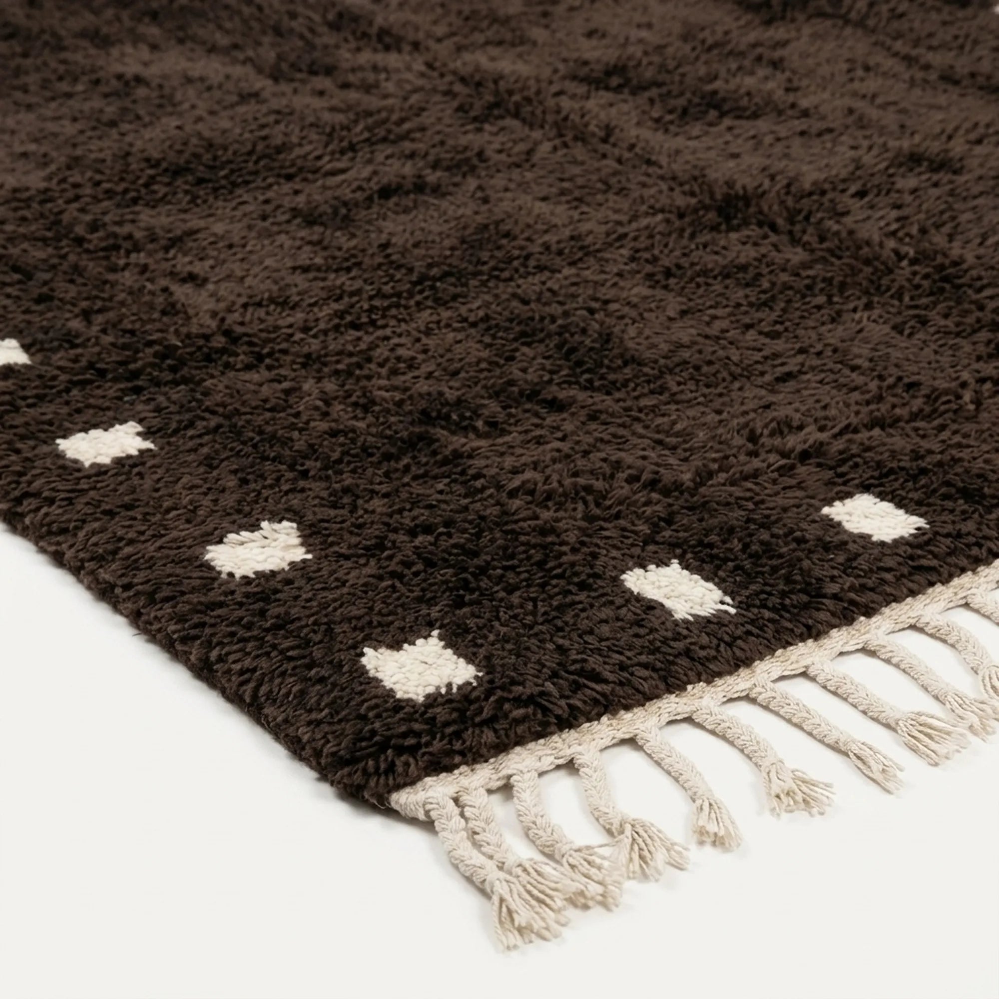 Natural wool pile detail on the dark brown and ivory square border rug.