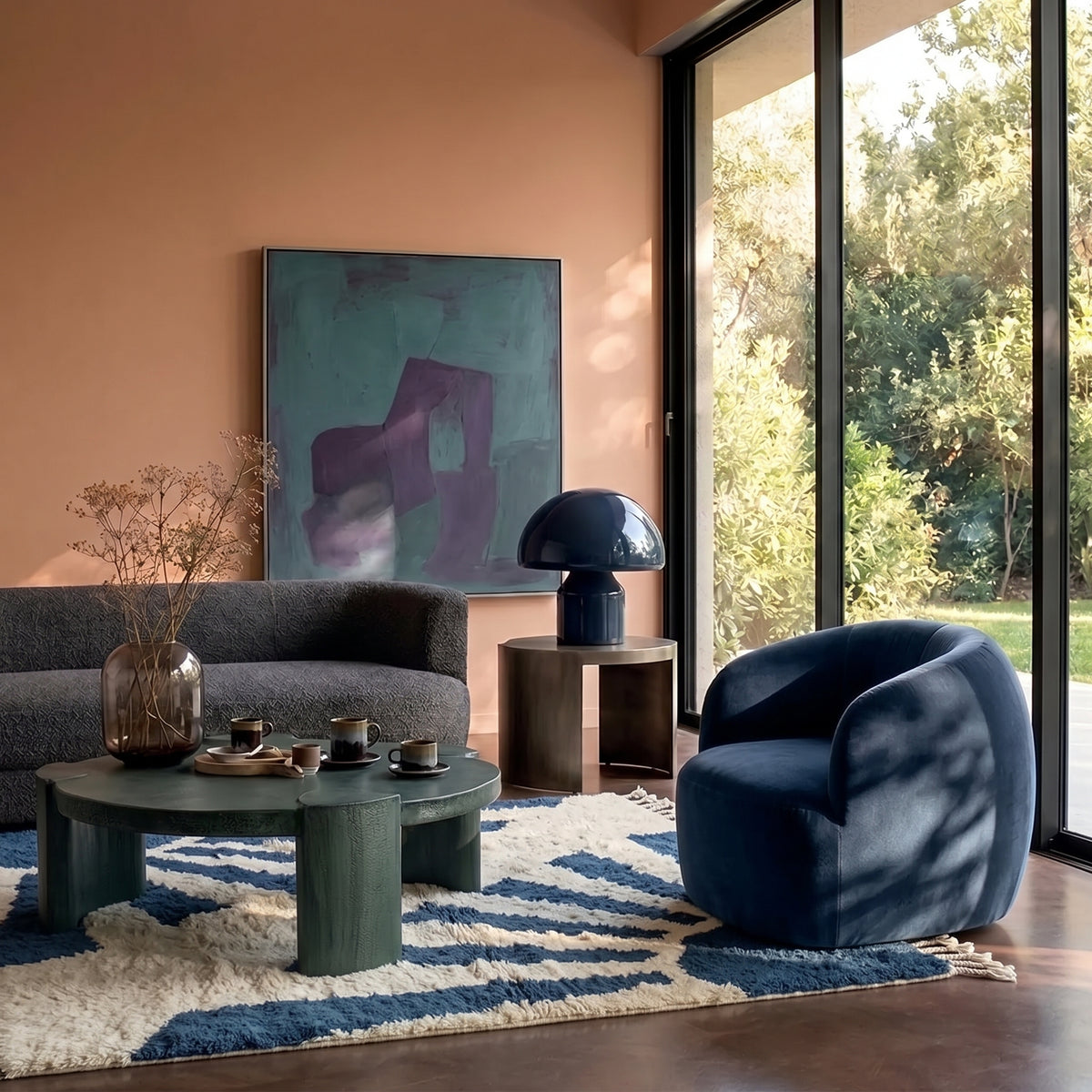 Denim & Ivory Beni Ourain Rug in modern living room with grey sofa, blue chair, and green round table