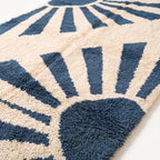 Close-up of knotted wool pile showing denim and ivory radiant bands texture and depth
