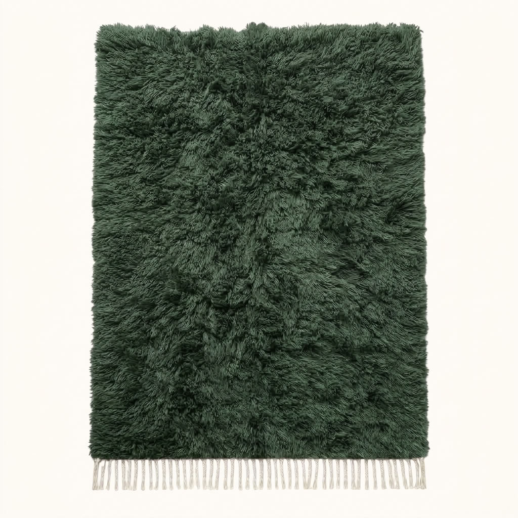 Forest green Beni Ourain rug Tafrara with textured pile and ivory fringe, flat lay on plain background