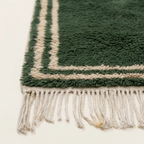 Close-up of the hand-tied ivory fringe on the Tafukt Beni Ourain rug.