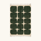 Full view of the Anir forest green and ivory Beni Ourain rug with a rounded grid design.