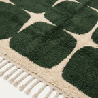 Angled view of the Anir forest green and ivory hand-knotted Beni Ourain rug.