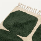 Fringe and edge detail of the Anir forest green and ivory hand-knotted rug.
