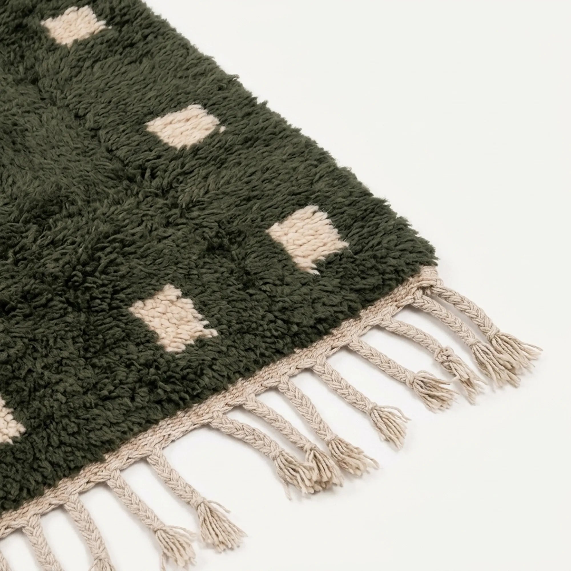 Natural wool pile detail on the forest green and ivory square border rug.