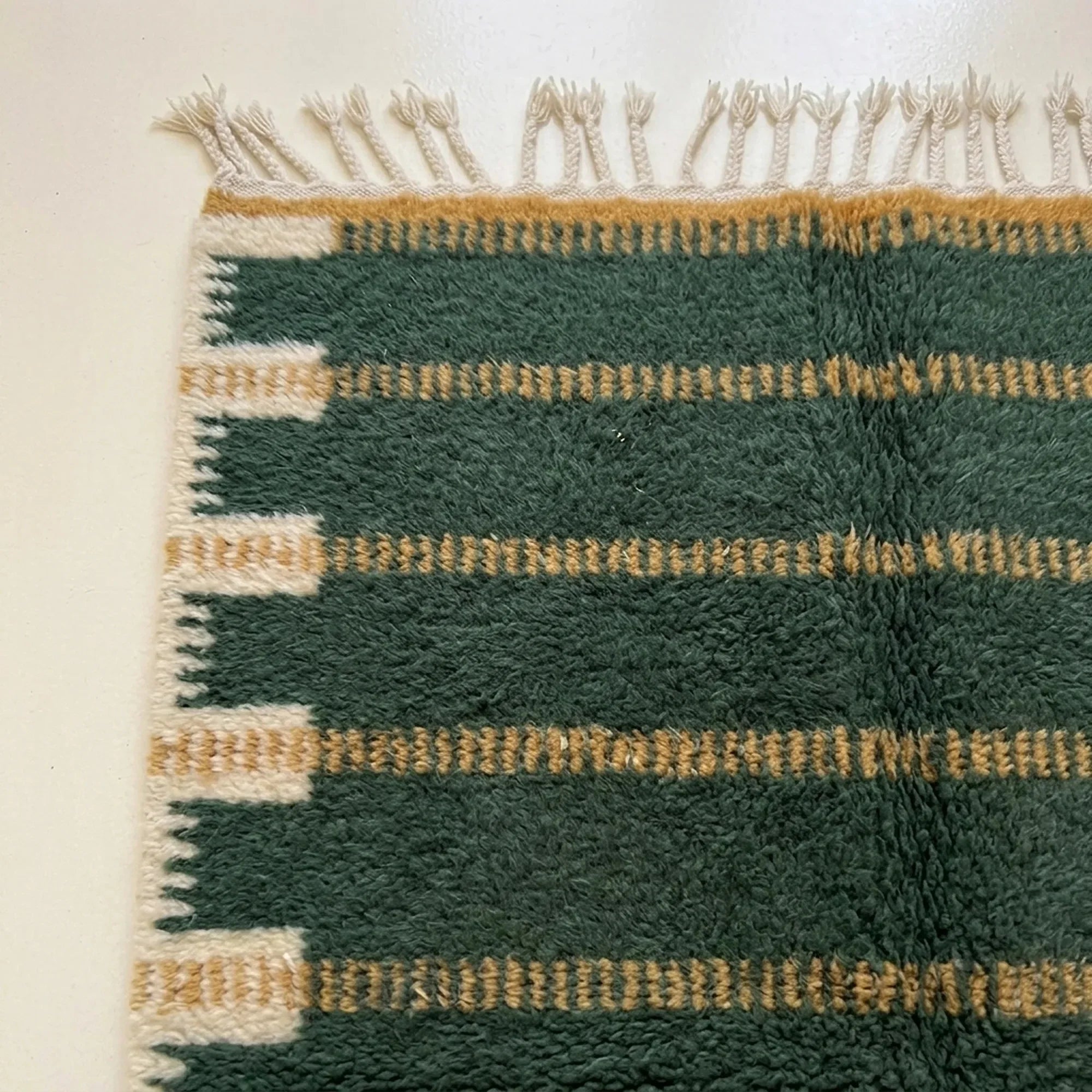 Full view of the Azru forest green, ochre and ivory Beni Ourain rug with a horizontal band design.