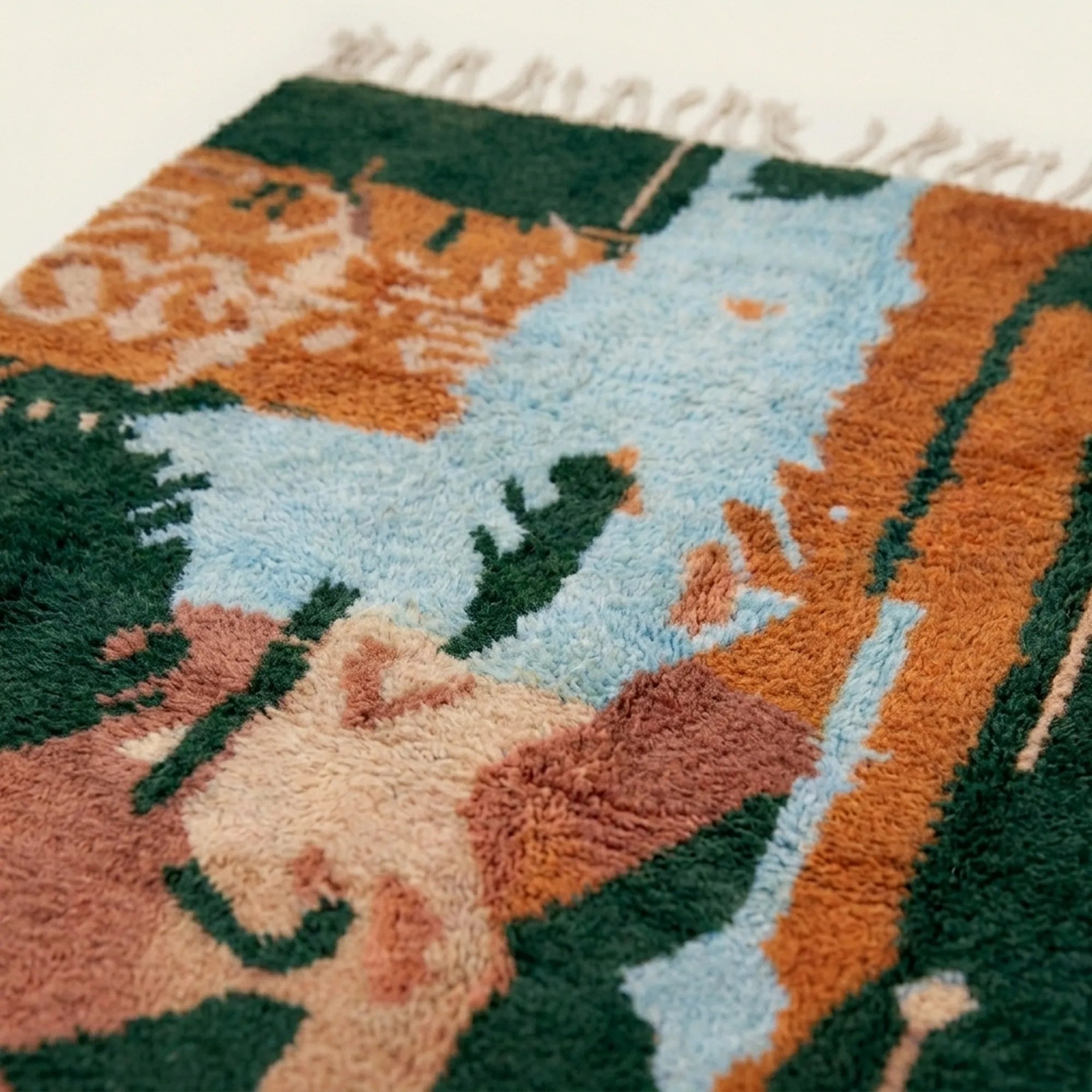 Fringe and lower-edge view of the Azelwan Boujaad rug with abstract forest green and terracotta motifs