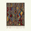 Full view of the Abridan Boujaad rug in gray, blue, red, green and ochre with scattered diamonds and zigzag symbols