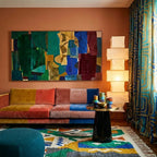 Awragh Boujaad rug styled in a living room with its green, mustard and cobalt symbolic pattern visible