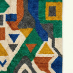 Pattern close-up of Awragh showing green, cream, cobalt, ochre and terracotta symbolic geometric forms