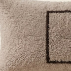 Side view of the Ilis Moroccan pillow showing its grey and black wool pile