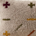 Side view of the Itri Moroccan pillow showing its grey and multicolor wool pile