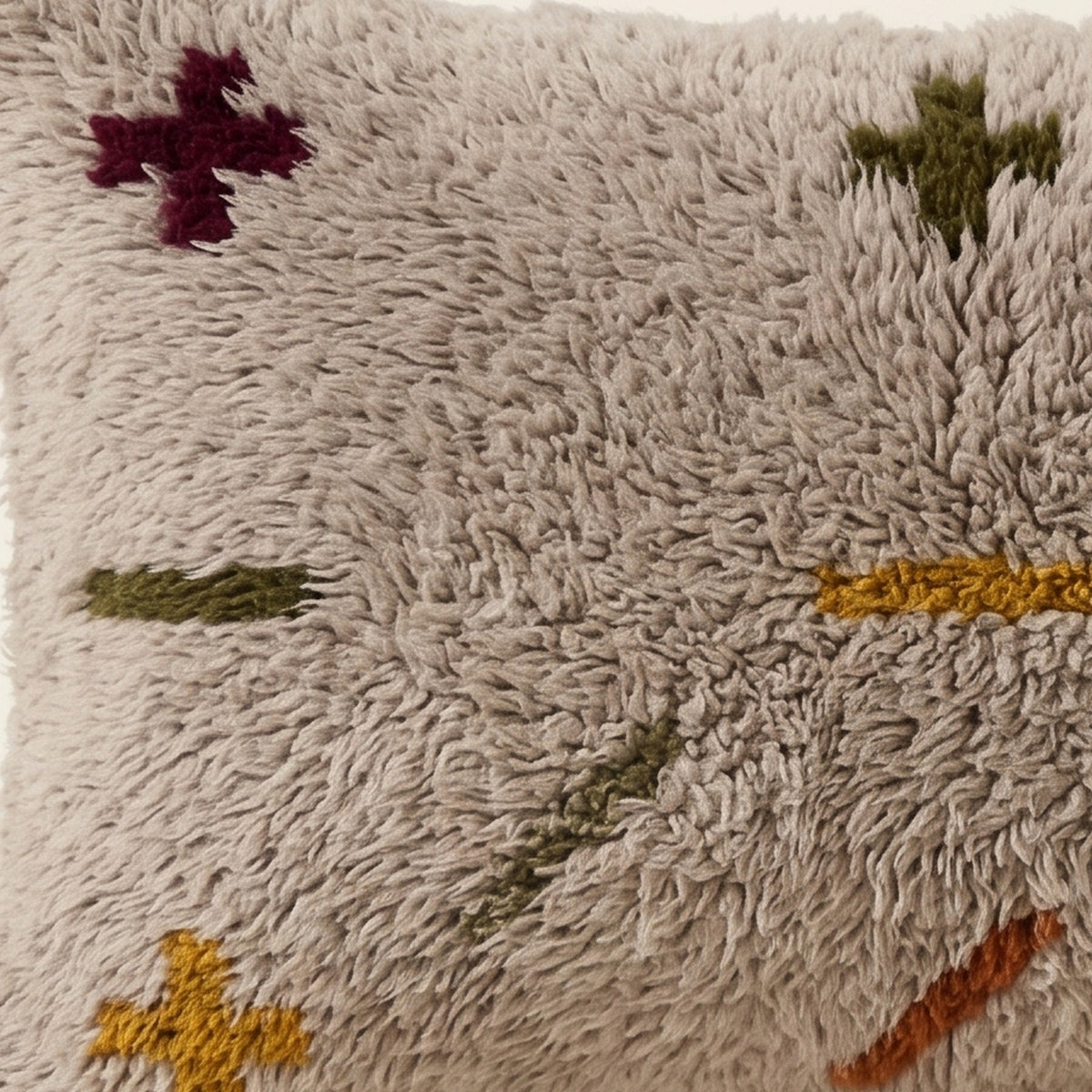 Side view of the Itri Moroccan pillow showing its grey and multicolor wool pile