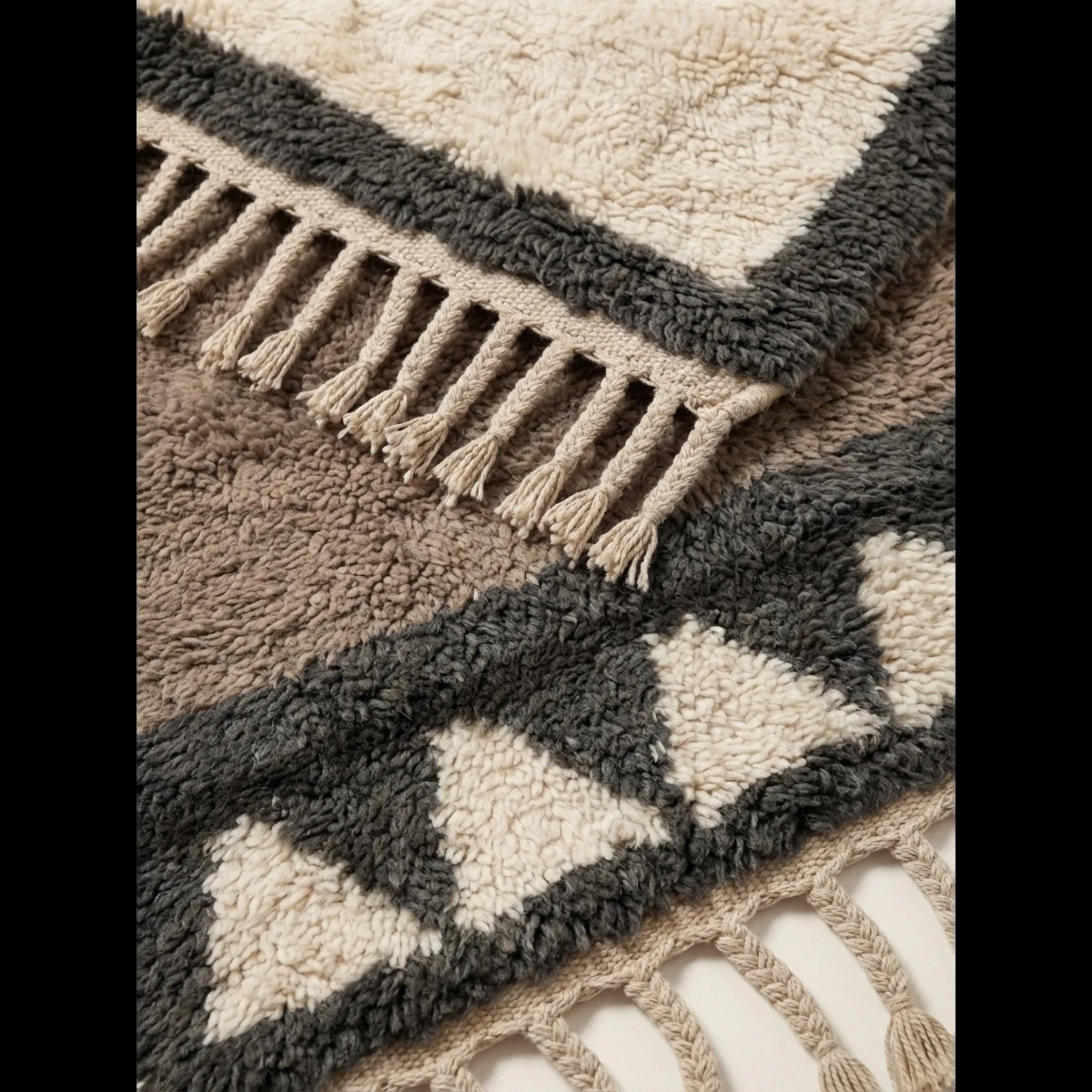 Hand-tied fringe and plush Atlas wool detail of the Imilchil taupe rug.