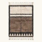 Full view of the Imilchil taupe Beni Ourain rug with a framed triangle motif and hand-tied fringe.