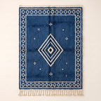 Indigo and Ivory Beni Ourain rug with concentric diamond motif, flat lay on neutral background