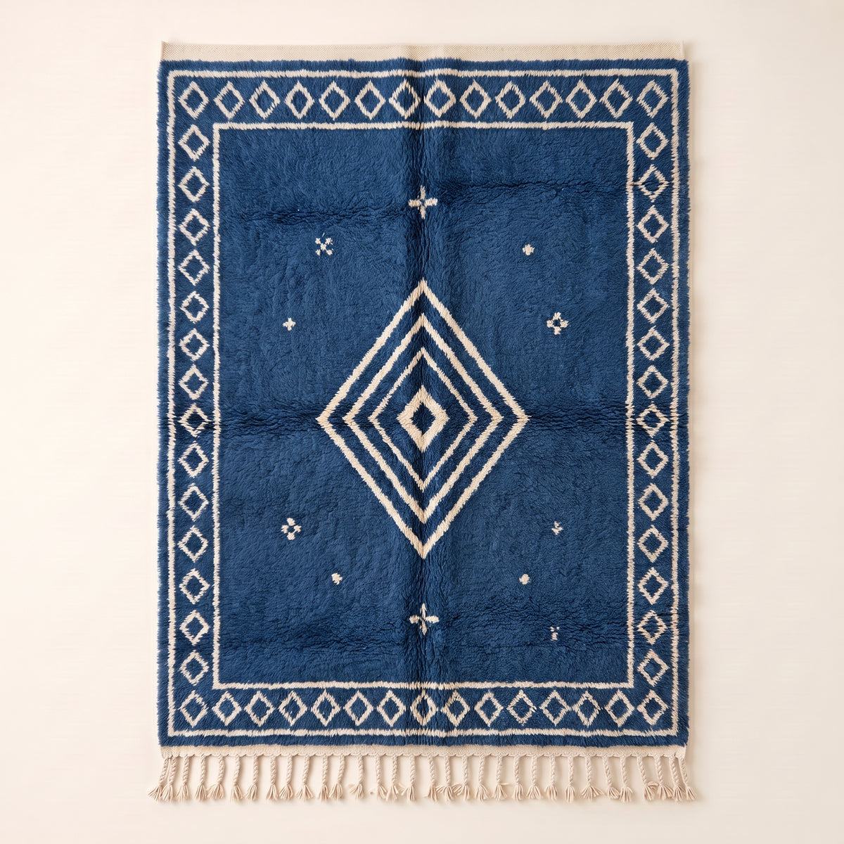 Indigo and Ivory Beni Ourain rug with concentric diamond motif, flat lay on neutral background