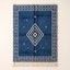 Indigo and Ivory Beni Ourain rug with concentric diamond motif, flat lay on neutral background