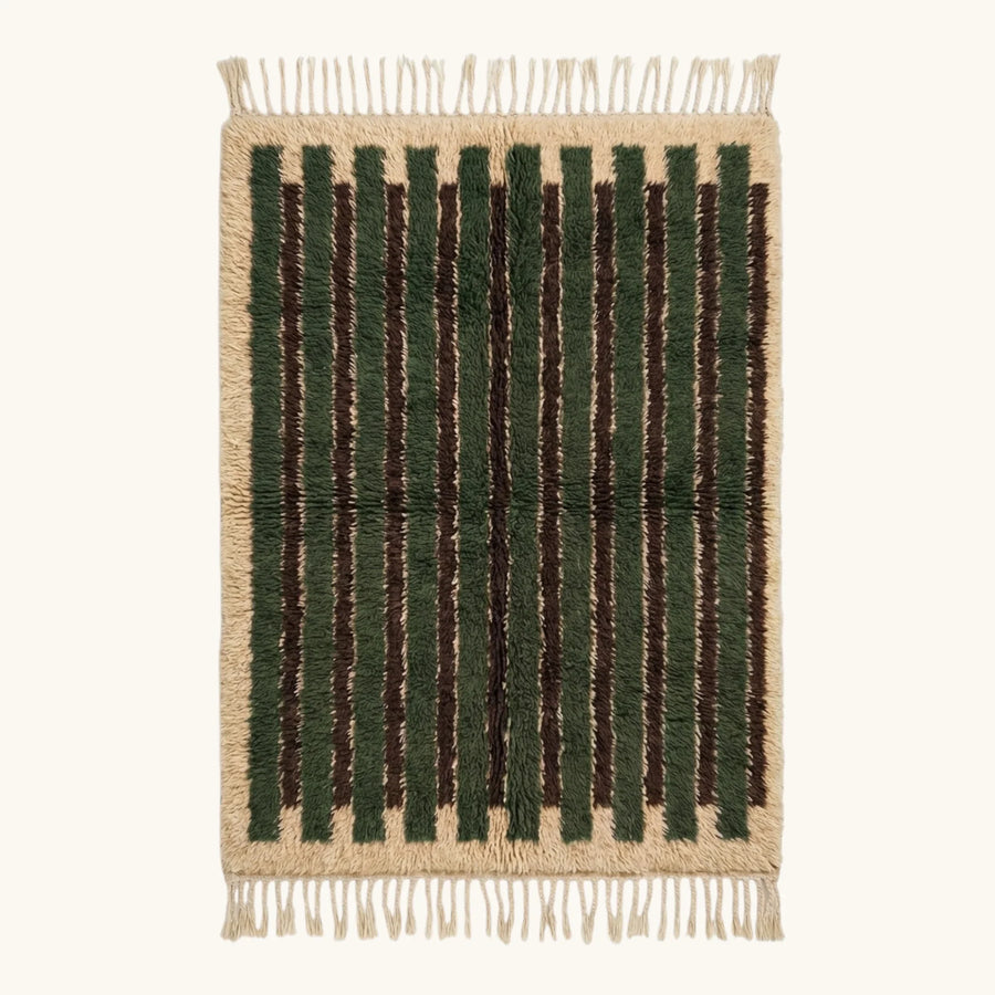 Full view of the Itri green Beni Ourain rug with organic stripes and hand-tied fringe.